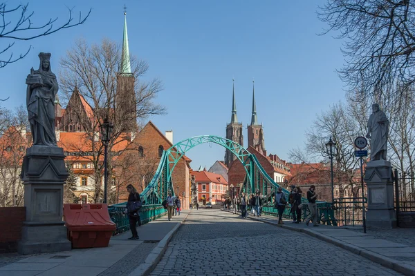 Wroclaw, Poland - circa March 2012: Most Tumski bridge, sculptures and towers of gothic Cathedral of St. John the Baptist in Wroclaw,  Poland