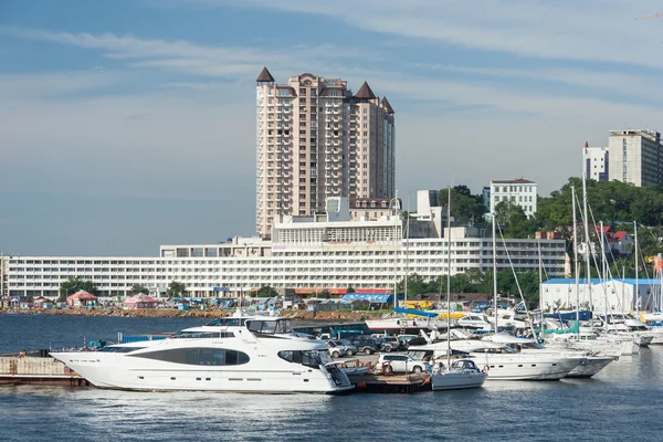 Vladivostok, Russia - circa August 2014: Sailing boats and high rise residential buildings in Vladivostok,  Russia