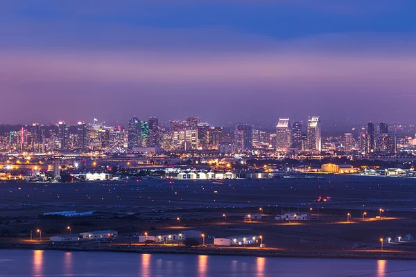 Military base with San Diego skyline in background after dusk