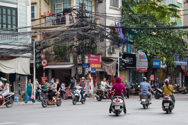 HANOI, VIETNAM - CIRCA AUGUST 2015: People riding motorbikes in street traffic in Hanoi,  Vietnam