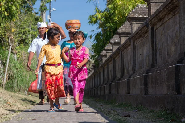 Village of Besakih, Bali/Indonesia - circa October 2015: Happy family are coming back from festival in Pura  Besakih
