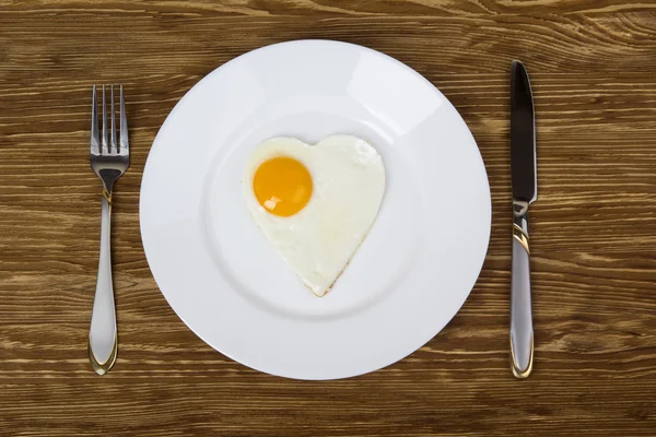 Breakfast with scrambled eggs in  heart-shaped Valentines Day