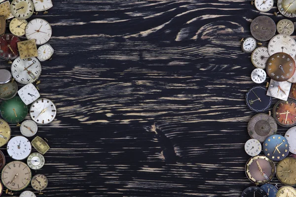 Old watches on a dark wooden  background.