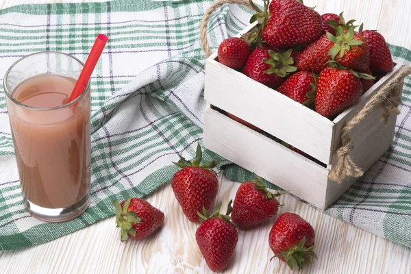 Strawberries in wooden box and juice