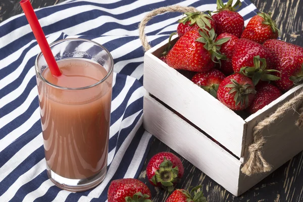 Strawberries in wooden box and juice