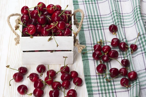 Red cherries in a wooden box