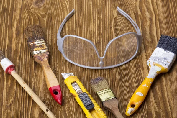 Construction tools: brushes, knife and glasses