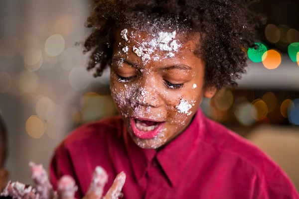 Childs face smeared in cake.