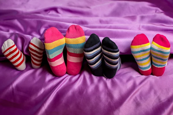 Small feet in colorful socks.