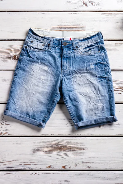 Close-up of womans jeans shorts.