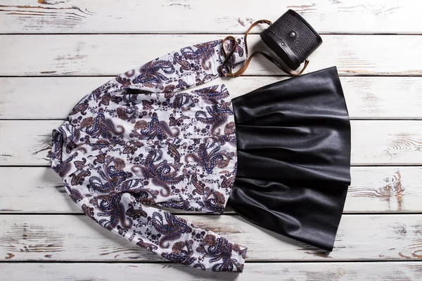 Black skirt with floral shirt.