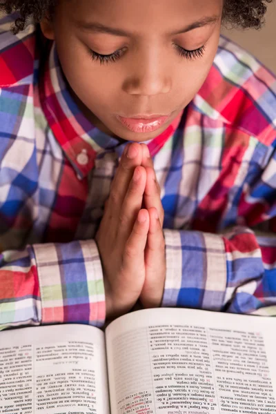 Mulatto boy praying.