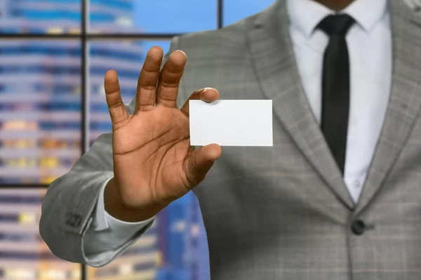 Black businessman shows visit card.
