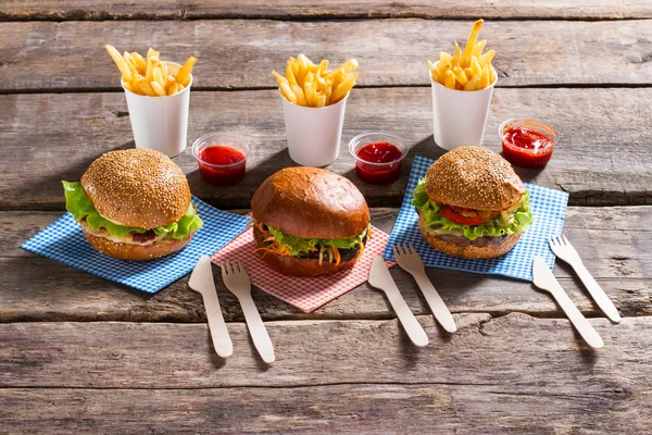Fries with cutlery and burgers.