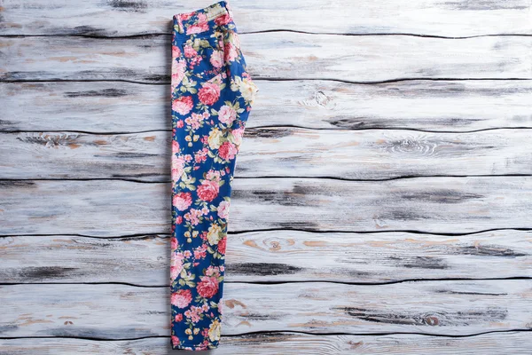 Blue pants with floral pattern.