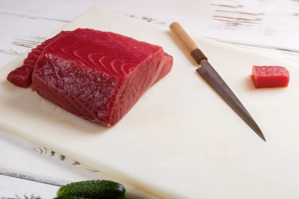 Raw fish meat and knife.