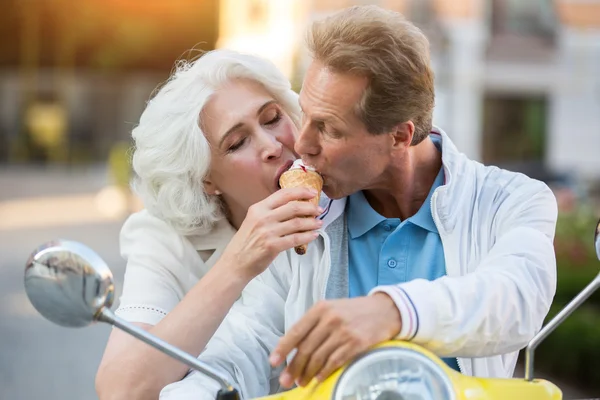 Mature couple shares ice cream.