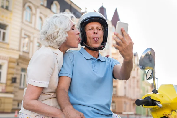 Mature couple showing tongues.