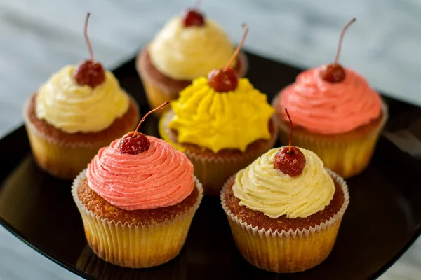 Bright cupcakes with cherries.