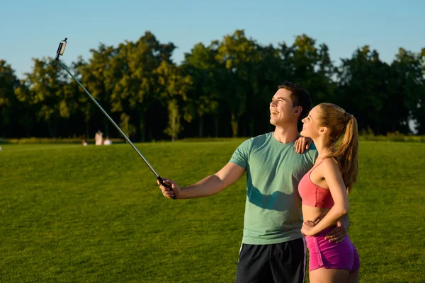 Guy and a girl make selfie on the golf course.