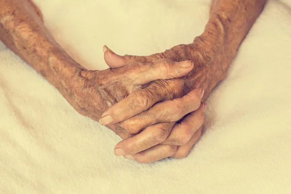 Hand of woman touching senior woman  in clinic. : Vintage filter