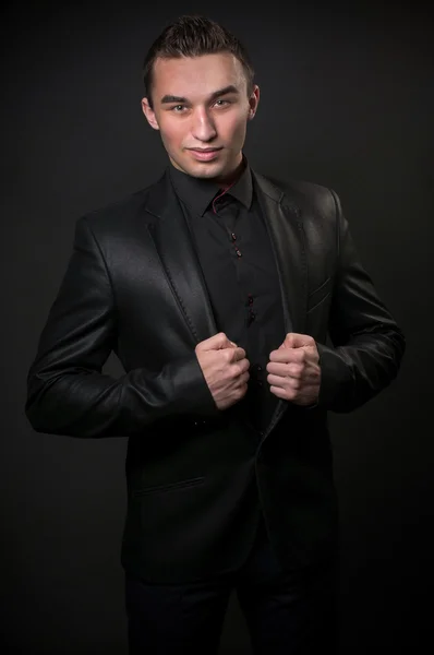 Fashion trendy elegant young man in black suit
