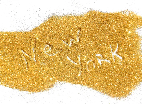 Blurry inscription New York on golden glitter sparkle on white b
