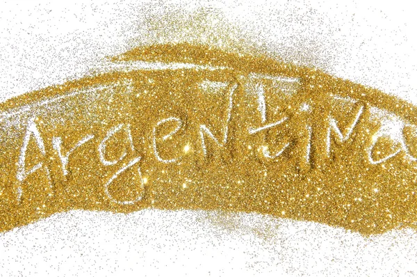 Blurry inscription Argentina on golden glitter sparkles on white background