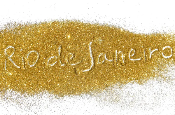 Blurry inscription Rio de Janeiro on golden glitter sparkles on white background