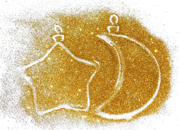 Two Christmas balls of golden glitter in the form of the crescent moon and the star sparkles on white background