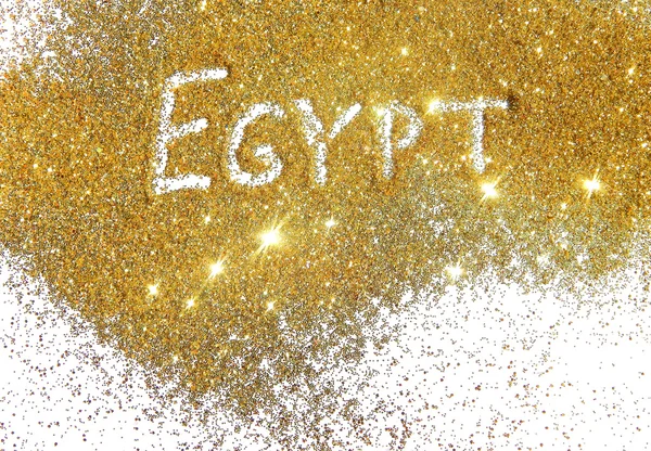 Inscription Egypt on golden glitter sparkle on white background