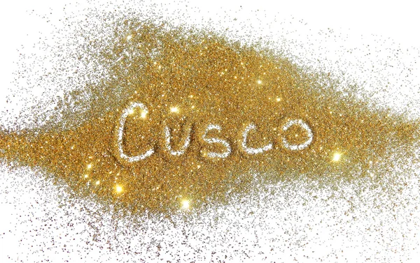 Blurry inscription Cusco on golden glitter sparkles on white background