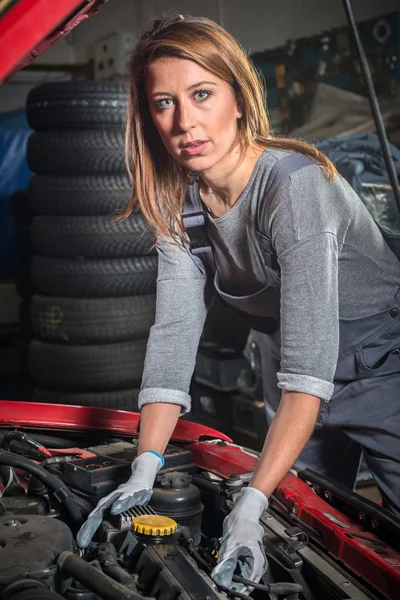 Female car mechanic in auto repair service