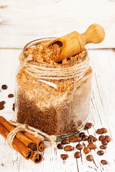 Homemade sugar scrub with coffee on a wooden background