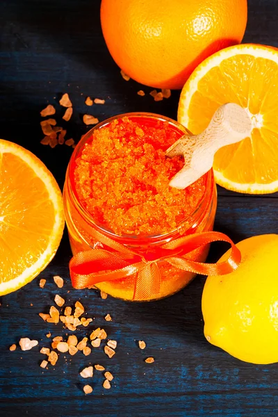 Homemade sugar scrub with Orange on a wooden background