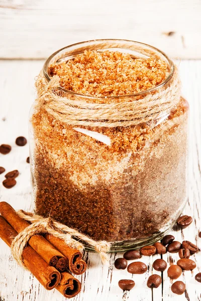 Homemade sugar scrub with coffee on a wooden background