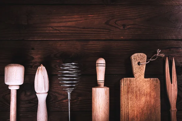 Kitchen tools on a wooden background. Applied toning. Top view.