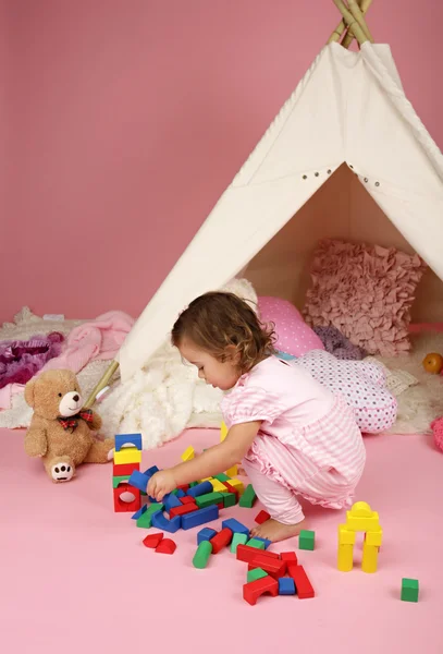 Toddler Girl Playing with BLocks and Toys