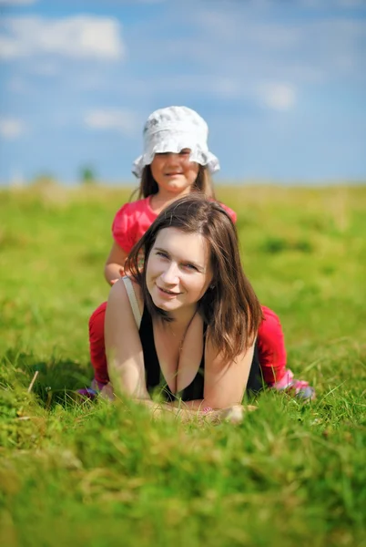 Mom and daughter on a meadow