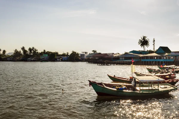 Boats in a harbor at sunset