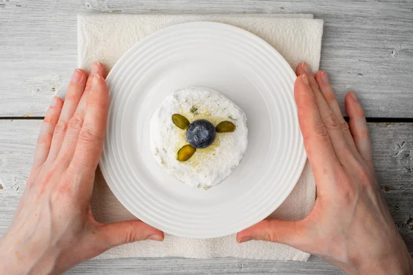 Cake with pistachio and blueberry  in the white plate in the hand