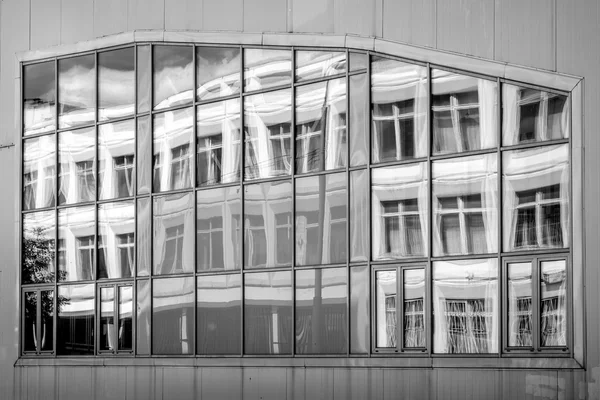 Window with building reflection black and white