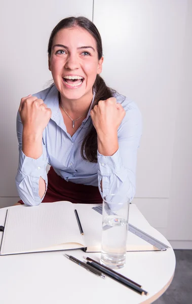 Young business woman is cheering her success