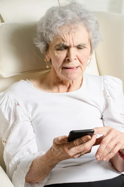 Old woman has problem with smartphone