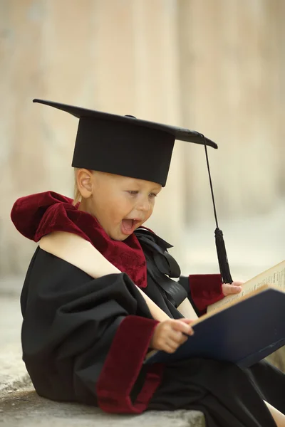 Funny little boy graduate of the University