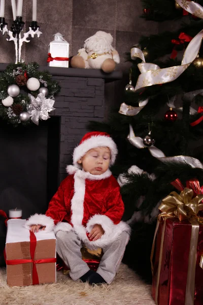 Santa baby sleeping under the Christmas tree