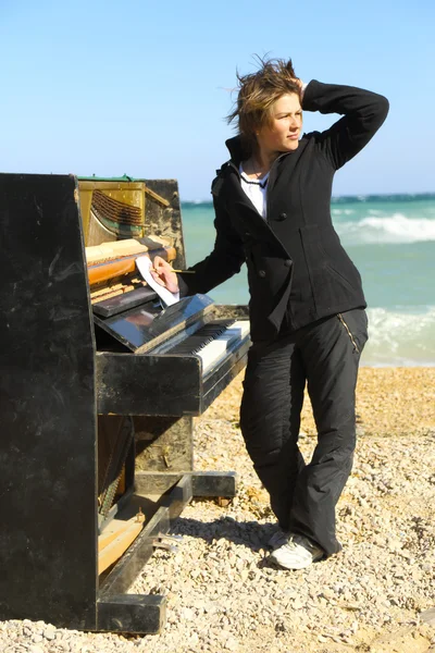 Pensive woman at the old piano