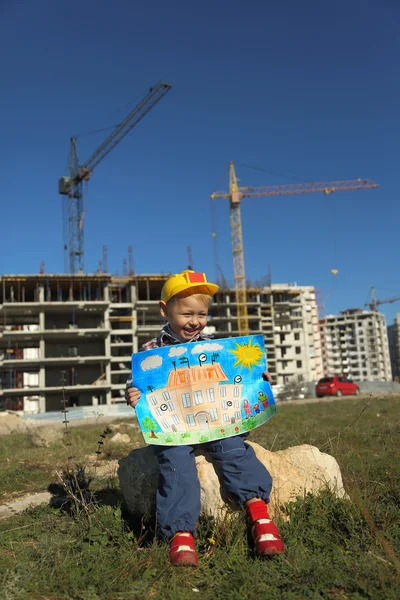 Funny boy with a picture of the future house