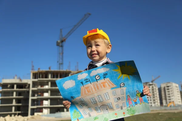 Funny boy with a picture of the future house