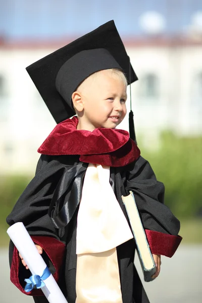 Funny kid dressed as a graduate of the University